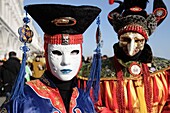 Chinese venetian mask at the Venice Carnival 2007, with the Doge's palace in the background, Venice, Italy