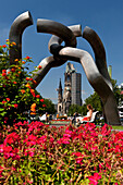 Flowers and the 'Berlin' sculpture in the Tauentzienstraße, Kaiser Wilhelm Memorial Church in the background, Berlin, Germany