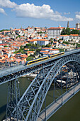 Train on Dom Luis bridge over River Douro with view of Ribeira District, Oporto, Douro, Portugal