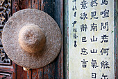 Conical hat on wall at Tuanshan village, Jianshui - near, China