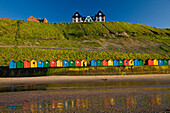 Colourful beach huts on North Beach, Whitby, Yorkshire, UK - England