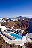 Clifftop swimming pool and view to Fira, Imerovigli, Santorini Island, Greek Islands