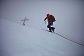 Mountaineer arriving summit of Grossvenediger, Venetian mountain range, Salzburg, Austria