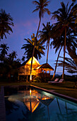 Pool and illuminated hut at Bon Ton Resort in the evening, Lankawi Island, Malysia, Asia