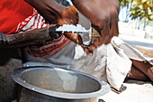 Woman preparing coconut flakes, Jambiani, Zanzibar, Tanzania, Africa