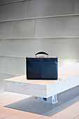 Black Briefcase on White Stone Bench, Seattle, Washington, USA