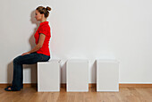 Young woman sitting on stool, Vienna, Austria