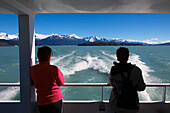 Two women on board a ship on the passage to the glaciers at Lago Argentino, Los Glaciares National Park, near El Calafate, Patagonia, Argentina