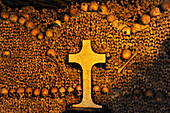 Pile of bones and cross in the catacombs, Paris, France, Europe