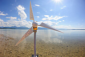 Model of wind power plant at shore of lake producing electricity, lake Chiemsee, Chiemgau, Upper Bavaria, Bavaria, Germany, Europe