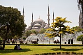 Tourists in front of Sultanahmet Mosque, also known as the Blue Mosque and Sultan Ahmed Mosque, Istanbul, Turkey