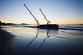 Santa Barbara, California: Sailboat washed ashore on beach during winter storm