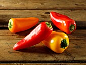 Mixed red, yellow & orange fresh mini peppers photos
