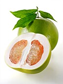 Fresh Pomelo grapefruit whole and cut with leaves