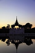 Myanmar, Burma, Mandalay, Palace, moat, watchtower silhouette, sunset
