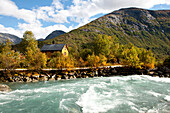 Tourquoise coloured river in front of a wooden house, Autumn, Trail to Nigardsbreen, Jostedalsbreen, Jostedalen, Sogn og Fjordane, Norway, Scandinavia, Europe