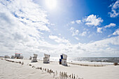 Roofed wicker beach chairs at sandy beach, Westerland, Sylt, Schleswig-Holstein, Germany