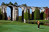 Golfer in front of the Aqueduct of Maintenon, Eure-Et-Loir (28), France