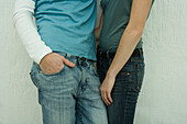 Young couple wearing jeans, mid section