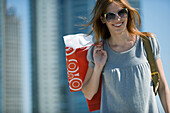 Young woman carrying shopping bags over shoulder