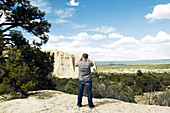 Tourist photographing El Morro National Monument, New Mexico, USA