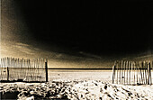 Fence on beach, b&w, toned