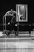 Bellhop pushing luggage cart