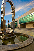 Modern artwork in plaza pool with building in background