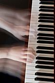 Blurred Hands on Piano Keys