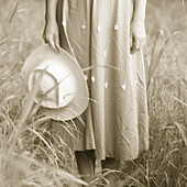 Close-Up of Woman's Skirt and Hat in Field