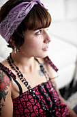 Young Woman With Tattoo and Pierced Nose