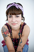 Smiling Young Woman With Nose Piercing and Tattoos