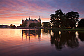 Schwerin Castle at lake Schwerin at sunset, State museum in the background, Schwerin, Mecklenburg Western-Pomerania, Germany