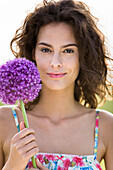 Portrait of a young  woman holding a flower