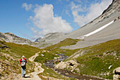 France, Alps, Savoie, Parc national de la Vanoise, hiker on a path