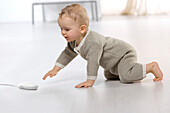 Baby on floor, computer mouse