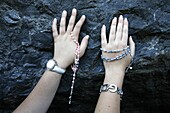 France, Lourdes, Pilgrims touching the Lourdes grotto