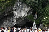 France, Lourdes, Pilgrim outside the Lourdes grotto