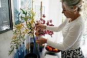 Woman with branches of chinese willow