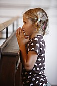 France, Saint Nicolas de Veroce, Girl praying in Saint-Nicolas de Véroce church