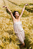 Young woman streching in wheat field