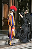 Latium, Rome, Nun and priest entering St Peter's basilica