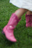 Blurred Girl Wearing Pink Boots on Lawn