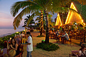 People in front of Chong Fah Restaurant at Bang Niang Beach in the evening, Andaman Sea, Indian Ocean, Bang Niang Beach, Khao Lak, Thailand, Asia