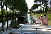 Couple on a boat, sitting arm in arm, Canal du Midi, Midi, France