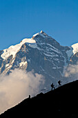 Two mountain hikers ascending, mount Jungfrau in backgound, Lauterbrunnen Valley, Canton of Bern, Switzerland