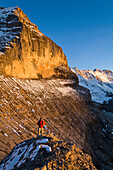 Hiker ascending Rotbraetthorn, Lauterbrunnen Valley, Canton of Bern, Switzerland