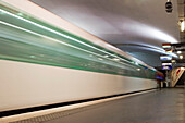 Subway train passing through underground station