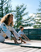 Women practicing yoga on a terrace, Vigilius Mountain Resort, Vigiljoch, Lana, Trentino-Alto Adige/Suedtirol, Italy