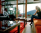 Couple in piazza lounge, Vigilius Mountain Resort, Vigiljoch, Lana, Trentino-Alto Adige/Suedtirol, Italy